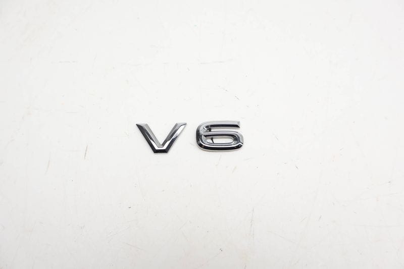 Trunk / Hatch Emblem / Badge (V6) 760853675 — Used (SKU 713666)